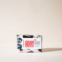 A bar of Cranberry dream soap with wrapping paper on a light background