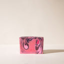A mottled pink bar of Cranberry Dream soap without wrapping paper