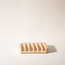 A concrete soap dish with channels for draining.