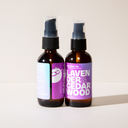 Two bottles of Lavender & Cedar Wood body oil with purple labels on a light background