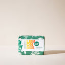 A bar of Lemon Blood Orange soap with green wrapping paper