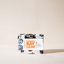 A bar of Tobacco and Bay Leaf soap with packaging on a light background